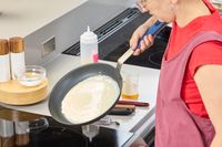 A person cooks crepes in the Misen Pre-Seasoned 10 Inch Carbon Steel Pan
