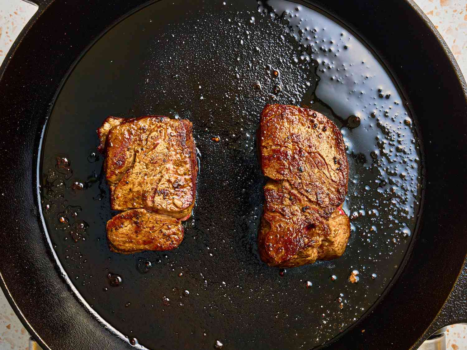 Overhead view of searing steak