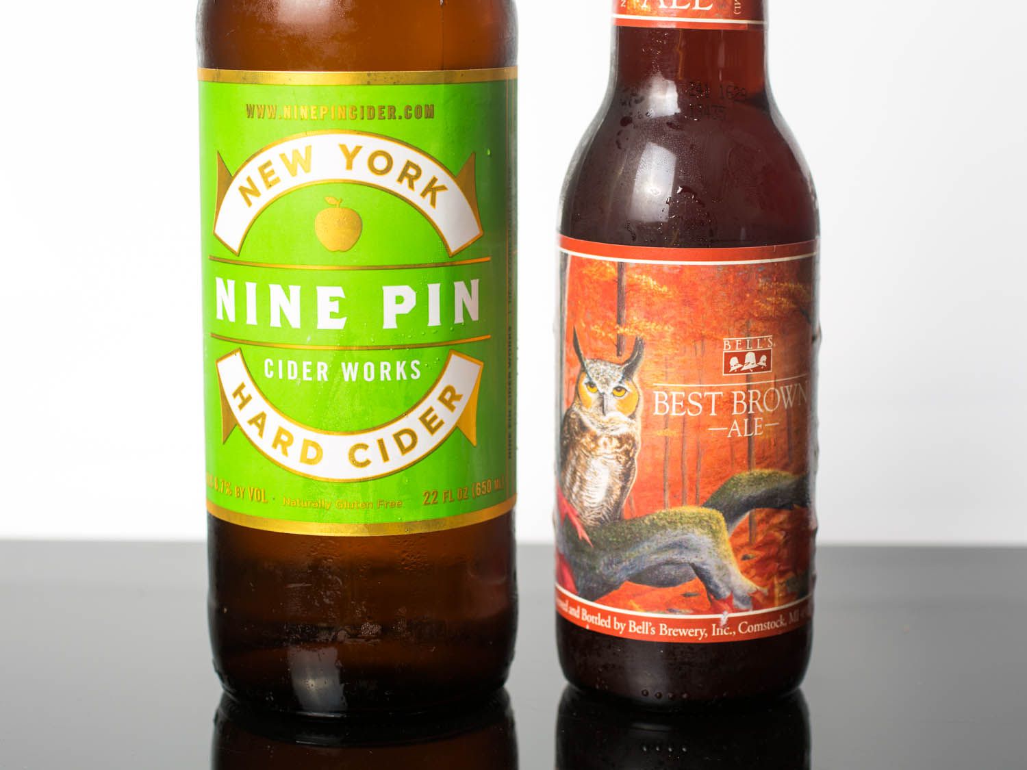 Closeup on the ingredients for a Candy Apple: a bottle of Nine Pin hard cider Bell's Best Brown Ale.