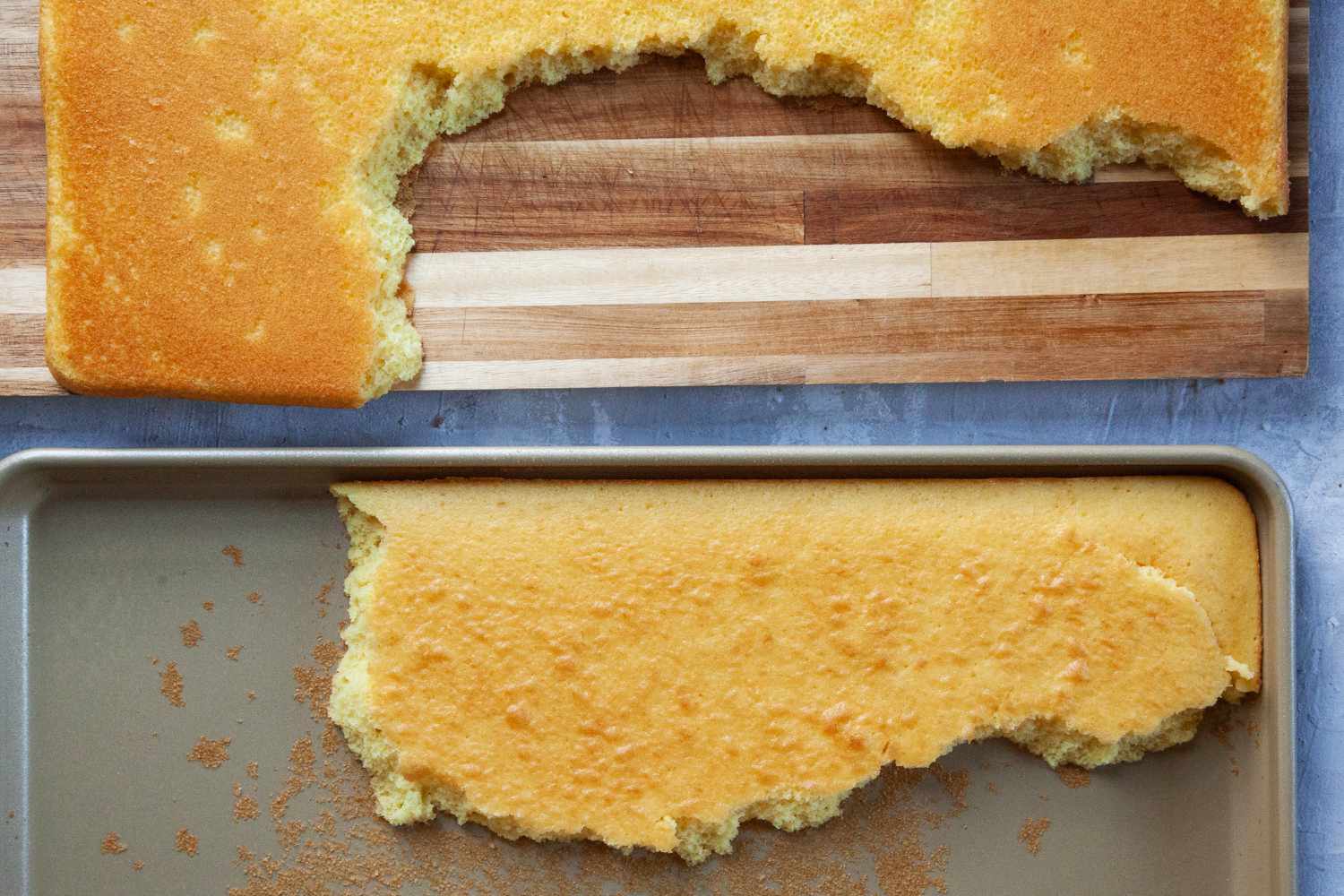 a broken sheet cake with a piece still stuck in the williams sonoma pan