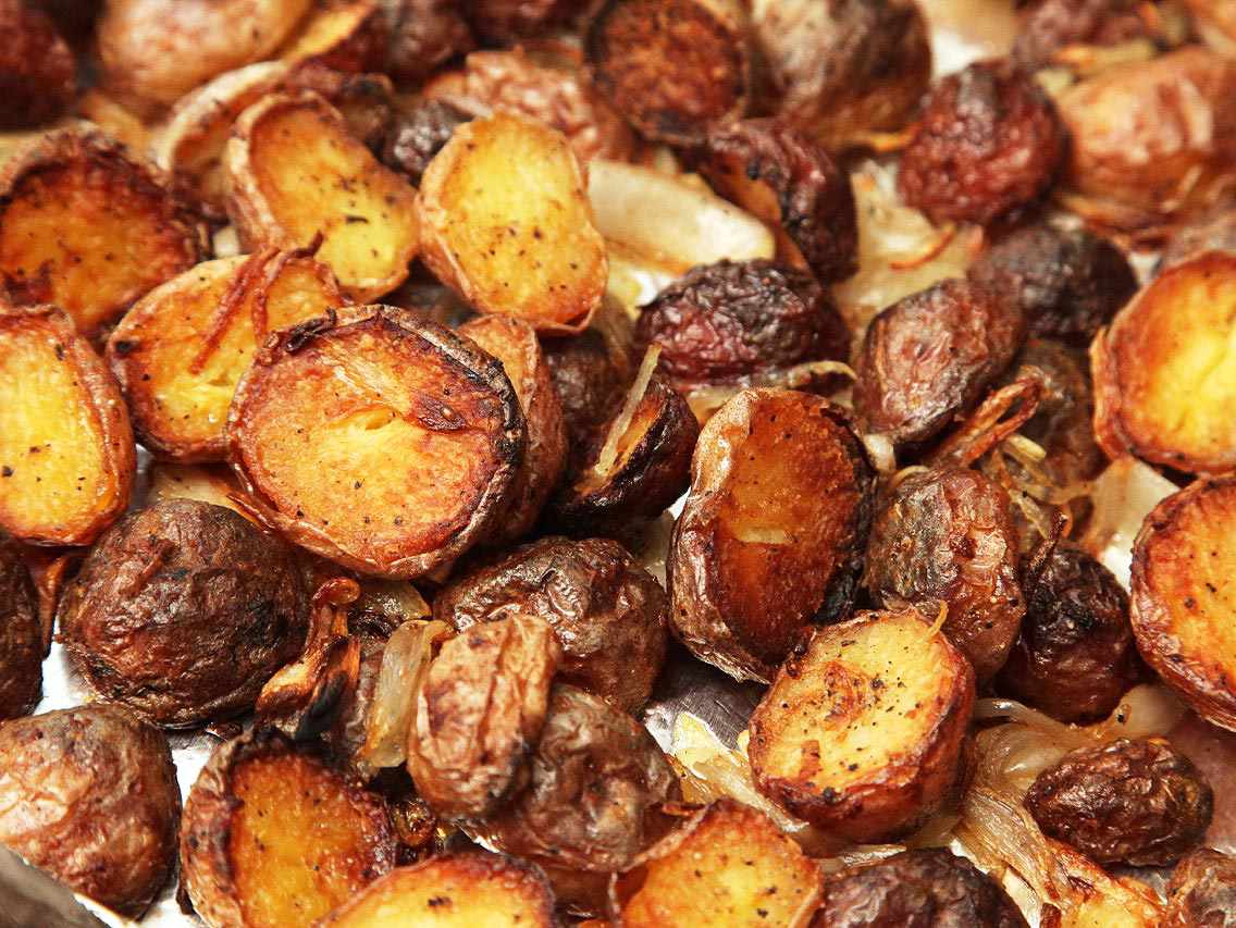 Closeup of dark golden brown roasted new potatoes.