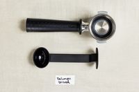 Parts of the portafilter for the De'Longhi Stilosa Espresso Machine on a table