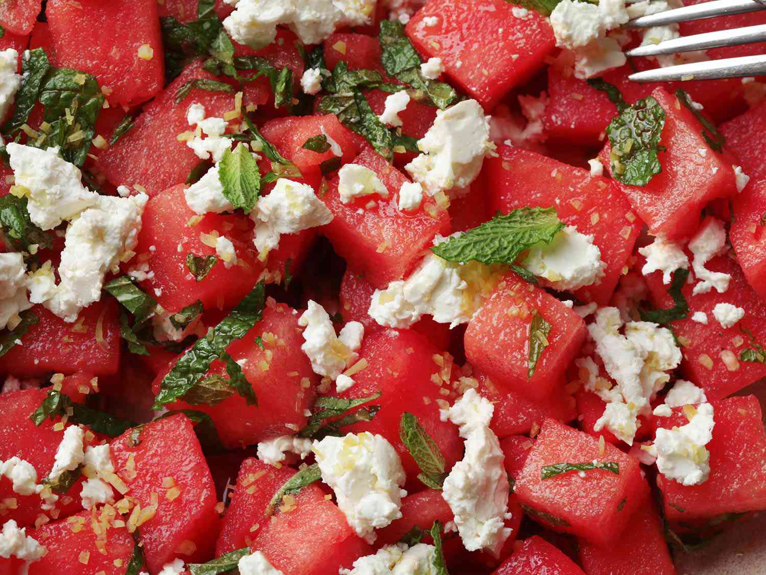 Close-up of cubed watermelon, mint, feta, and lemon zest.