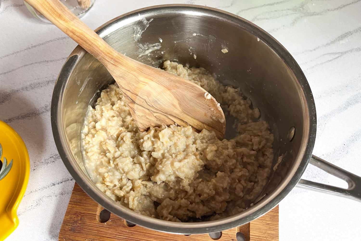 A pot of oatmeal with a Sabatier All-Purpose Spoon resting inside