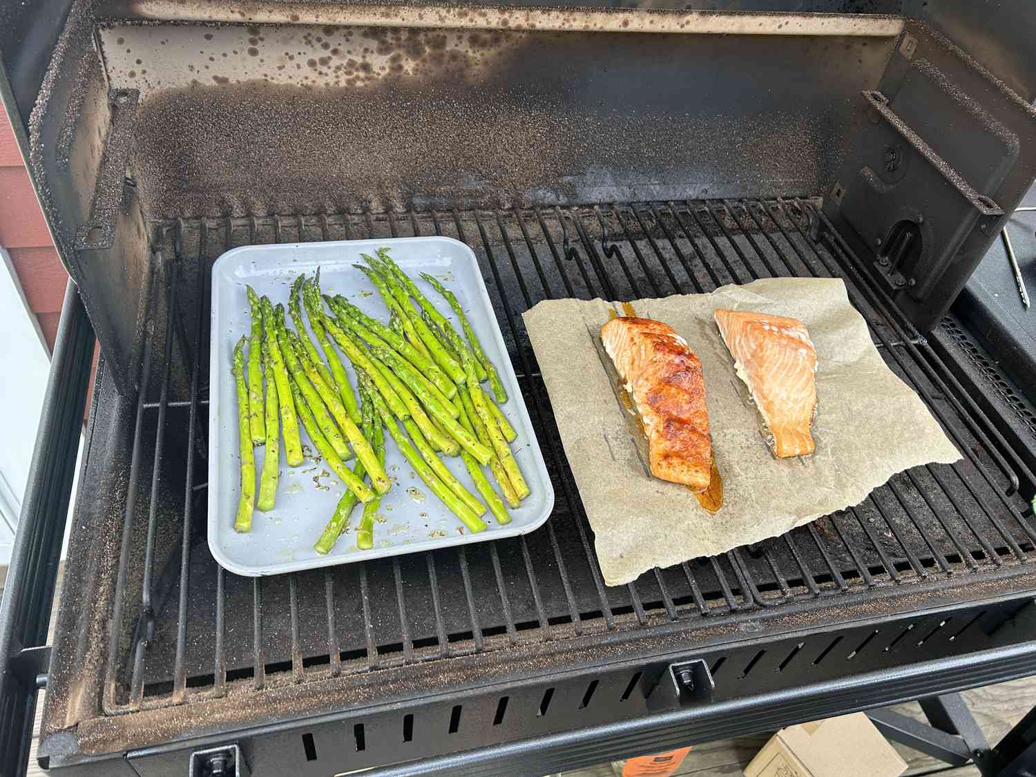 Salmon and asparagus cooking on the Traeger Woodridge pellet grill