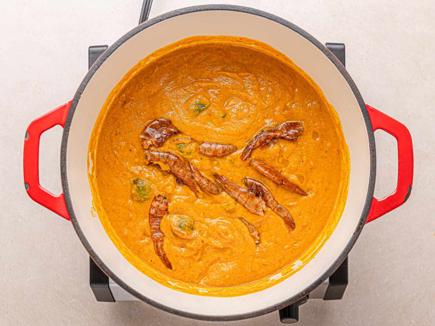 A pot of Nigerian egg sauce with dried chilies on top