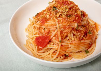 A plate of Sicilian spaghetti alla carrettiera made with fresh tomatoes.