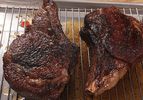 Two sous vide, pan-seared, and torched steaks resting on a rack.