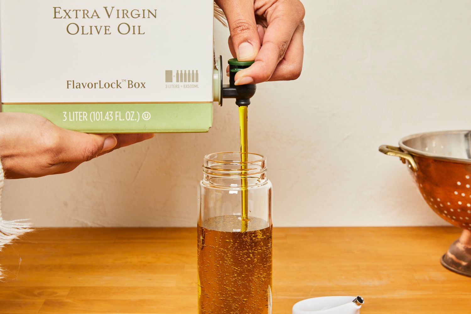 Olive oil being added to an oil dispenser.