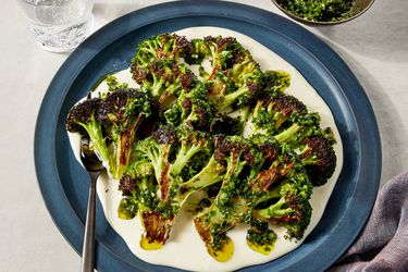 Overhead view of charred broccoli with taleggio cheese sauce