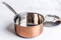a pot from the Cuisinart Copper Collection Tri-Ply Cookware 8-Piece Set on a white surface