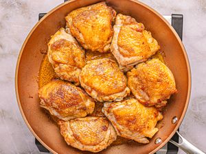 Cooked chicken pieces in a skillet, ready for a recipe or serving