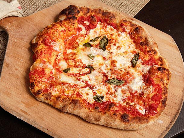 A pizza on a wooden peel