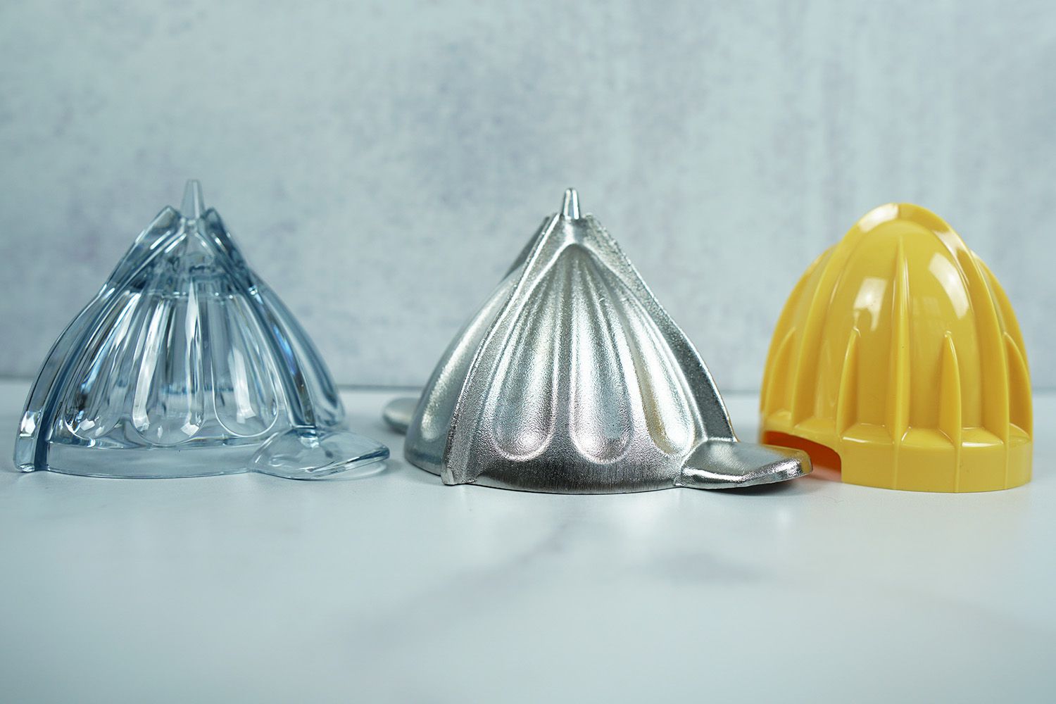 Three reamers of different materials and sizes on a marble surface