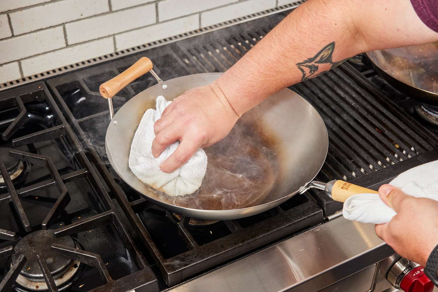 Person cleaning a Joyce Chen Carbon Steel Wok