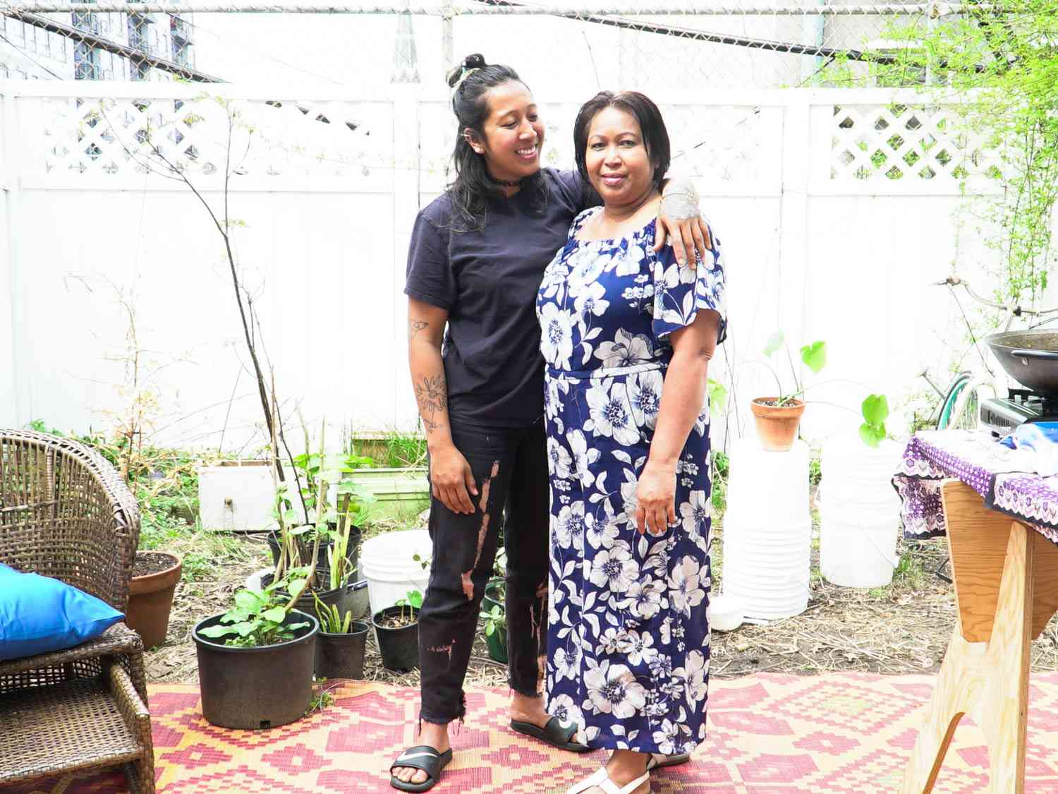 Chinchakriya and her mother Kim posing for the camera in a backyard.