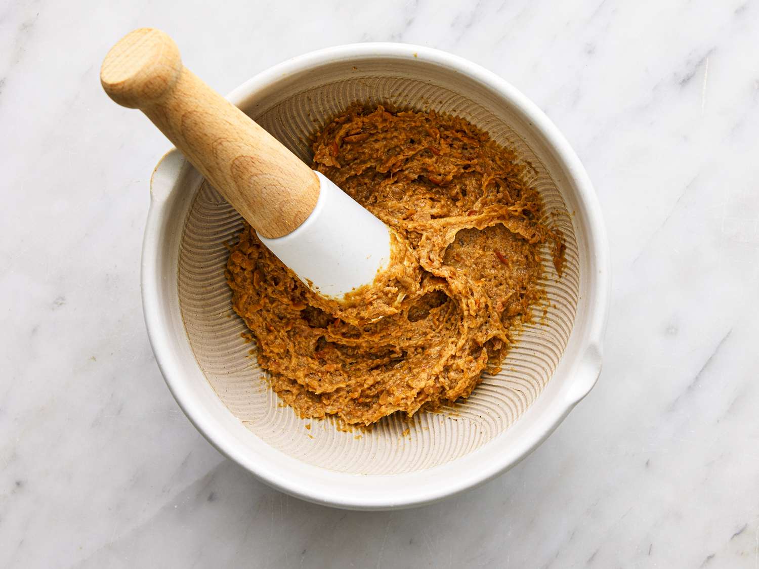 Overhead view of crushed natto in a mortar and pestle 
