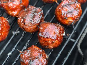 Glazed skewered MOINK balls on the grill
