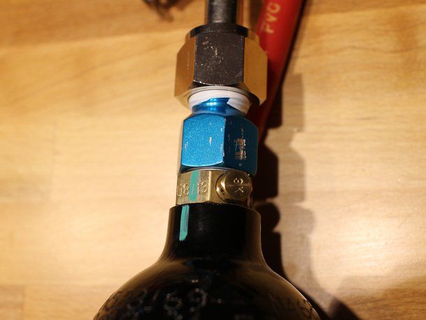 A close-up photo of where the pressurized tank connects to the adaptor.