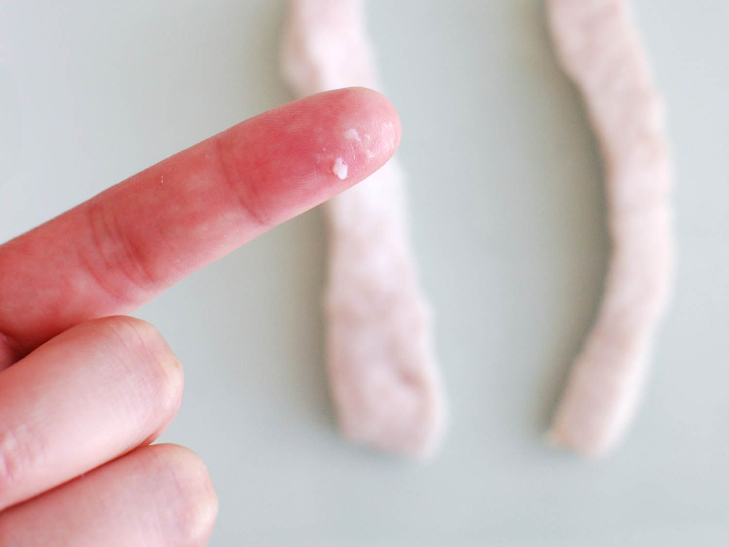 Finger with some cornstarch-egg white residue from water-blanching. 