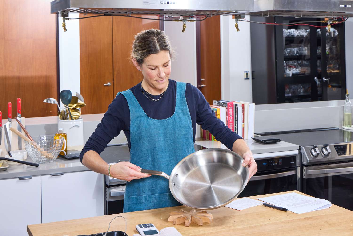 A person holds up the Made In 12-Inch Stainless Steel Skillet