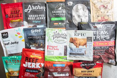 A display of various packaged beef jerky brands arranged on a table