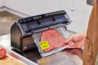 A person vacuum seals ground beef in the FoodSaver VS5960 Elite All-in-One Liquid+ Vacuum Sealer
