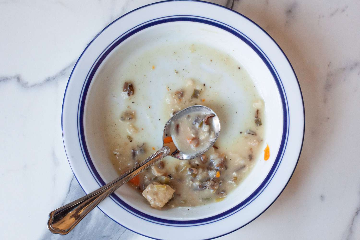 An almost empty bowl of soup
