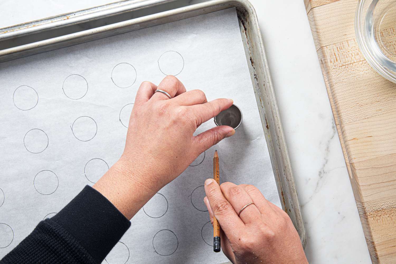 Overhead view of tracing circles on parchment paper