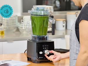 A person blending soup in the Vitamix Ascent X5 blender