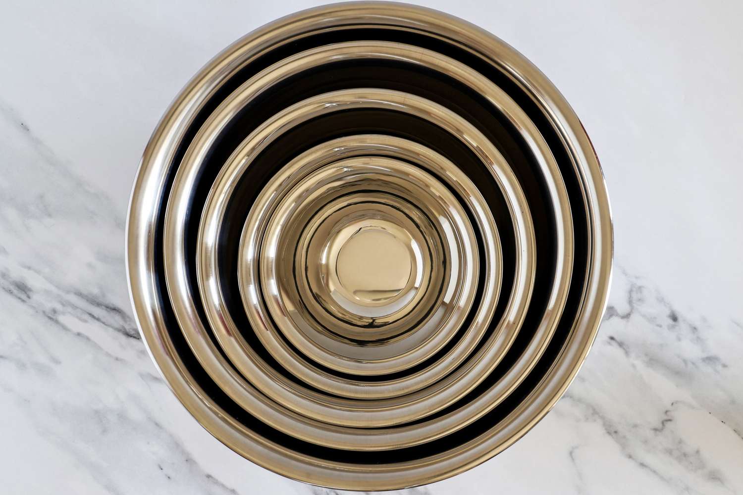 Set of Vollrath stainless steel mixing bowls on a marble surface