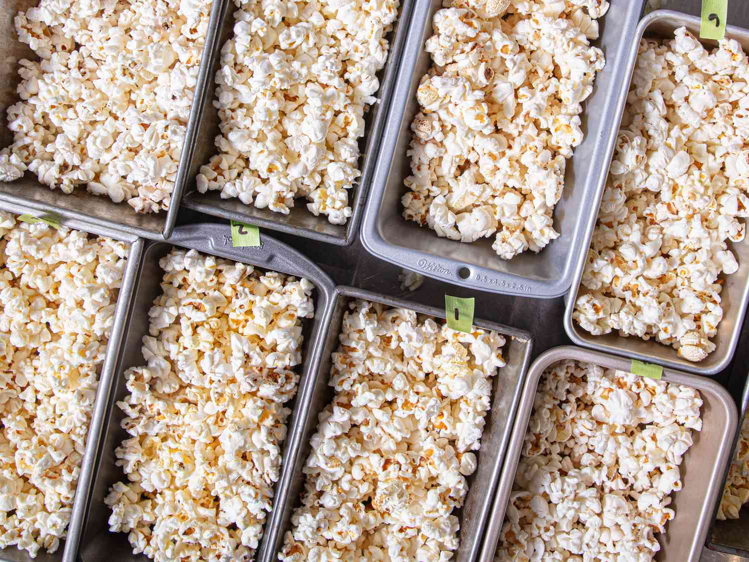 Several trays filled with popcorn, arranged in a grid pattern