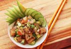 Hamachi poke with cucumber and avocado, served in a small bowl.