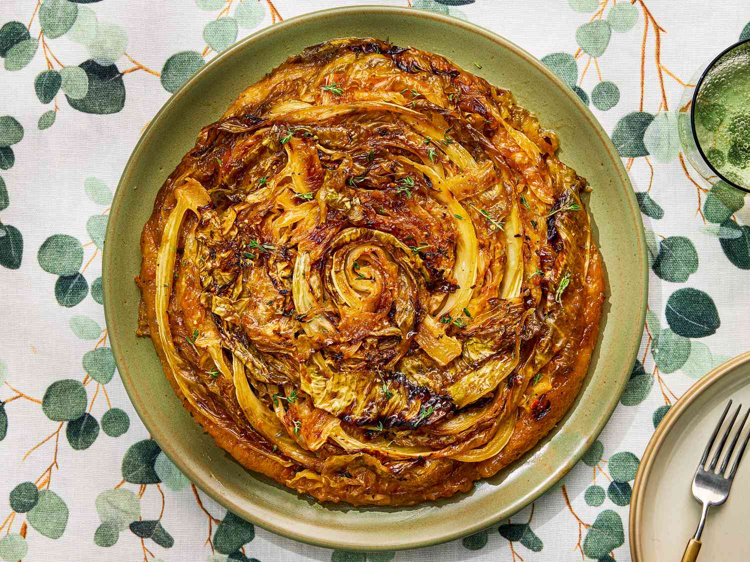 A savory cabbage tart tatin on a green plate