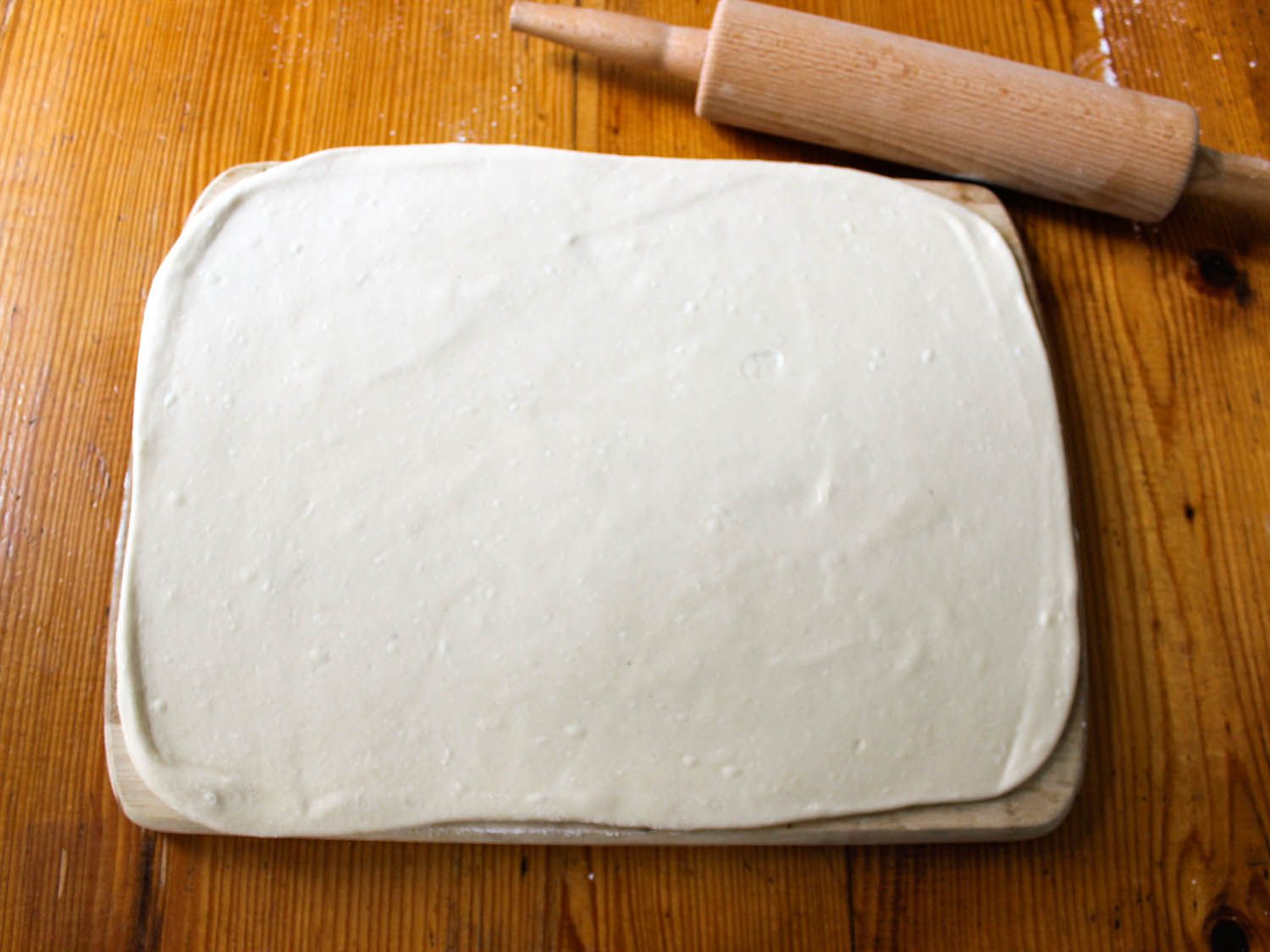 The dough is rolled out on a cutting board.