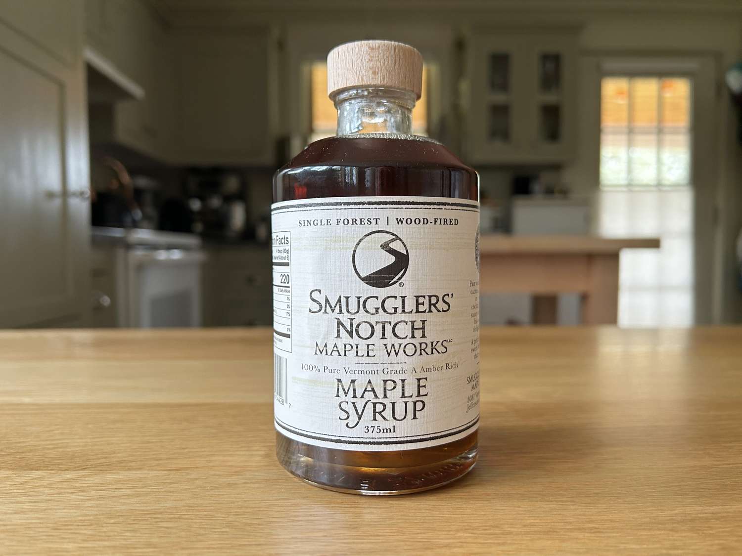 A bottle of Smuggler's Notch maple syrup on a kitchen table