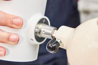 The KitchenAid shaved ice maker being attached to a stand mixer.