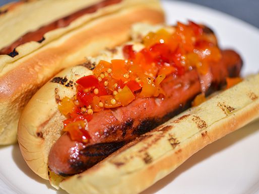 A grilled hot dog topped with pepper relish.