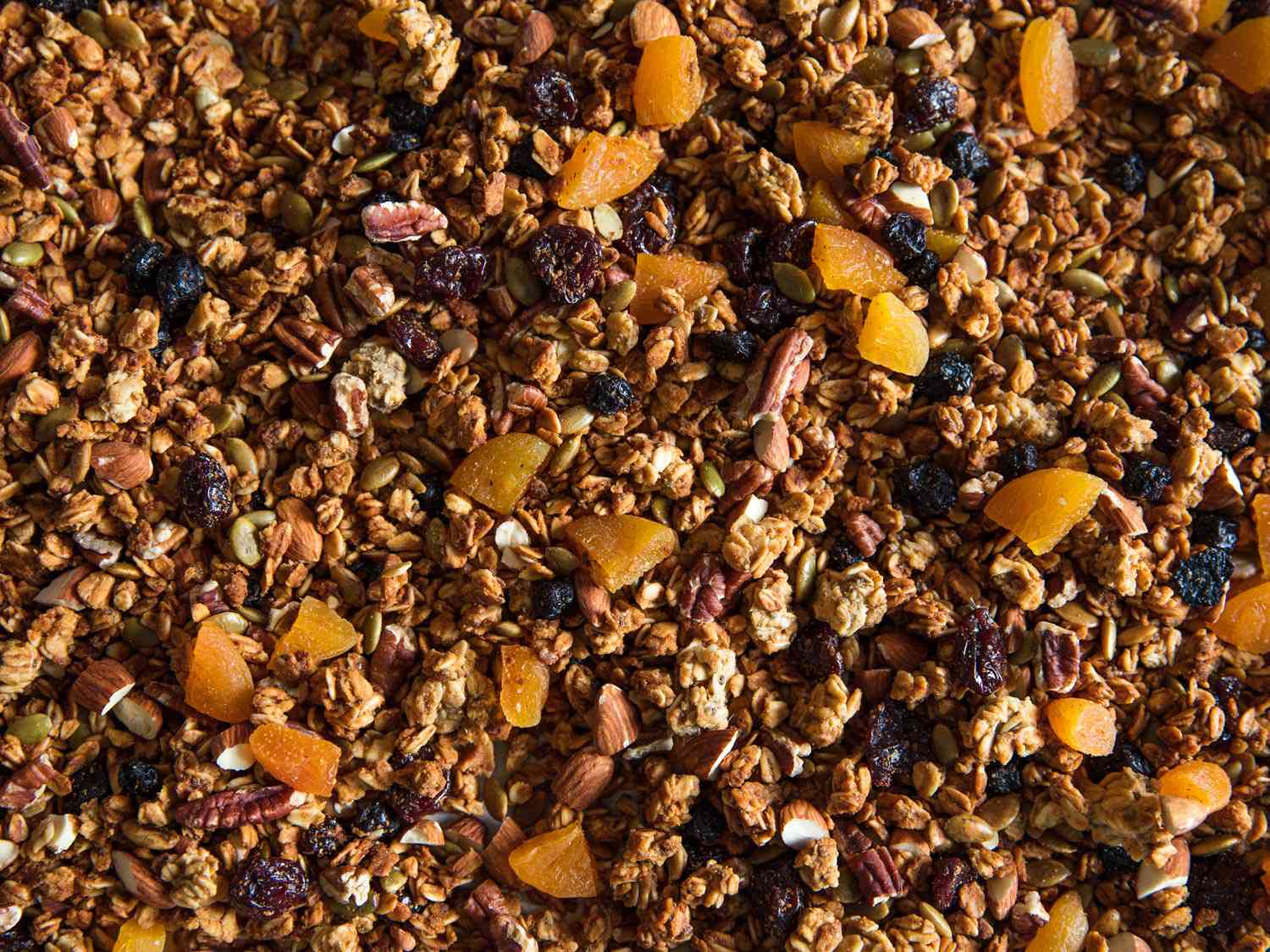 Top down view of homemade granola on a baking tray. 