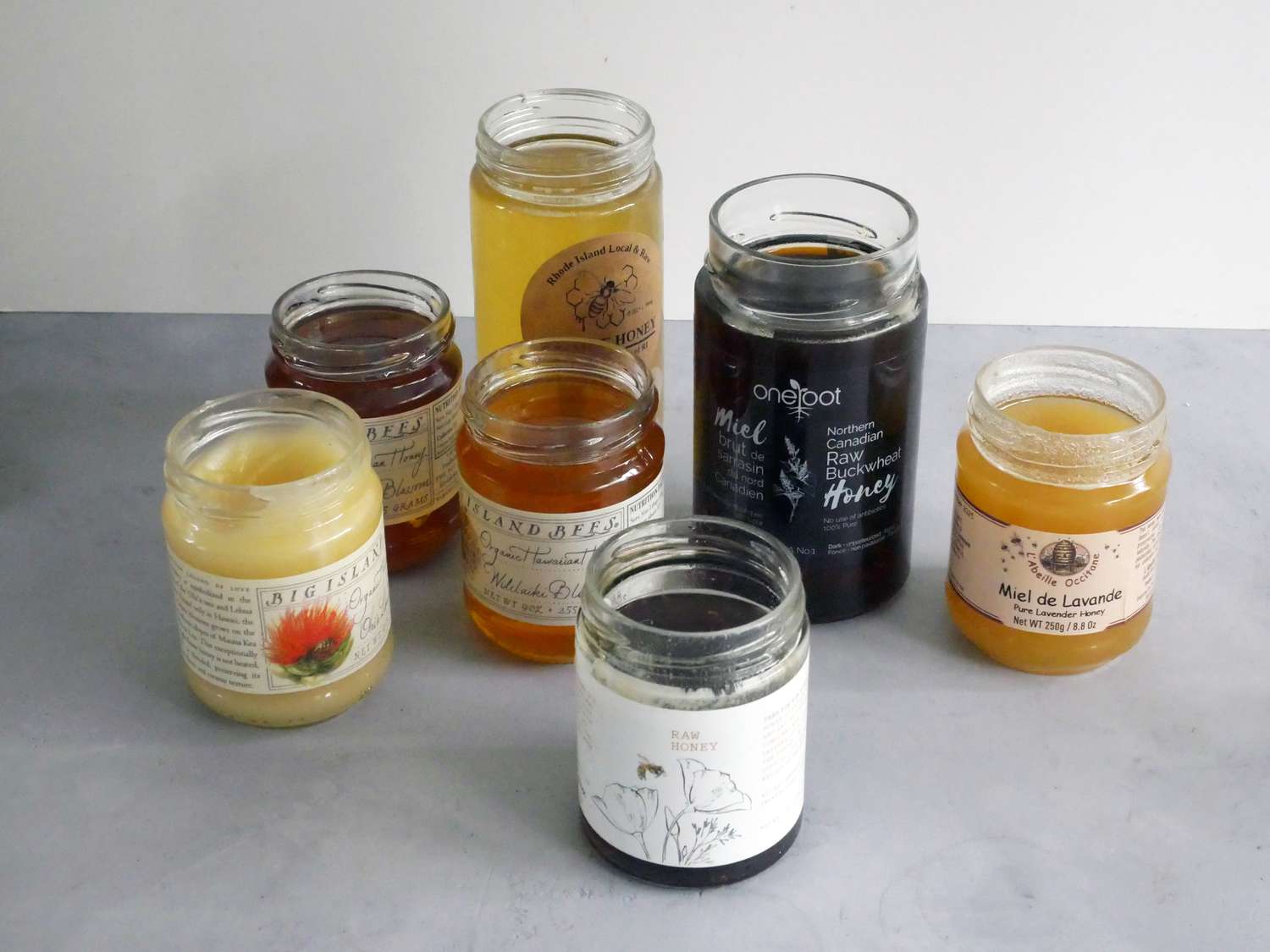 jars of honey on grey surface