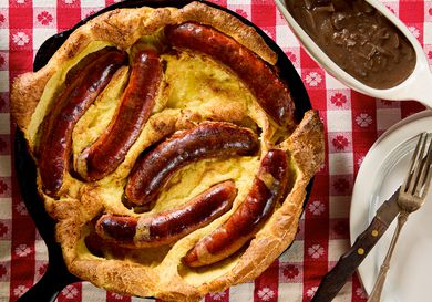 Toad in the Hole served in a skillet with a red checkered tablecloth