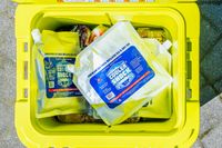 A yellow cooler containing Cooler Shock ice packs and food items