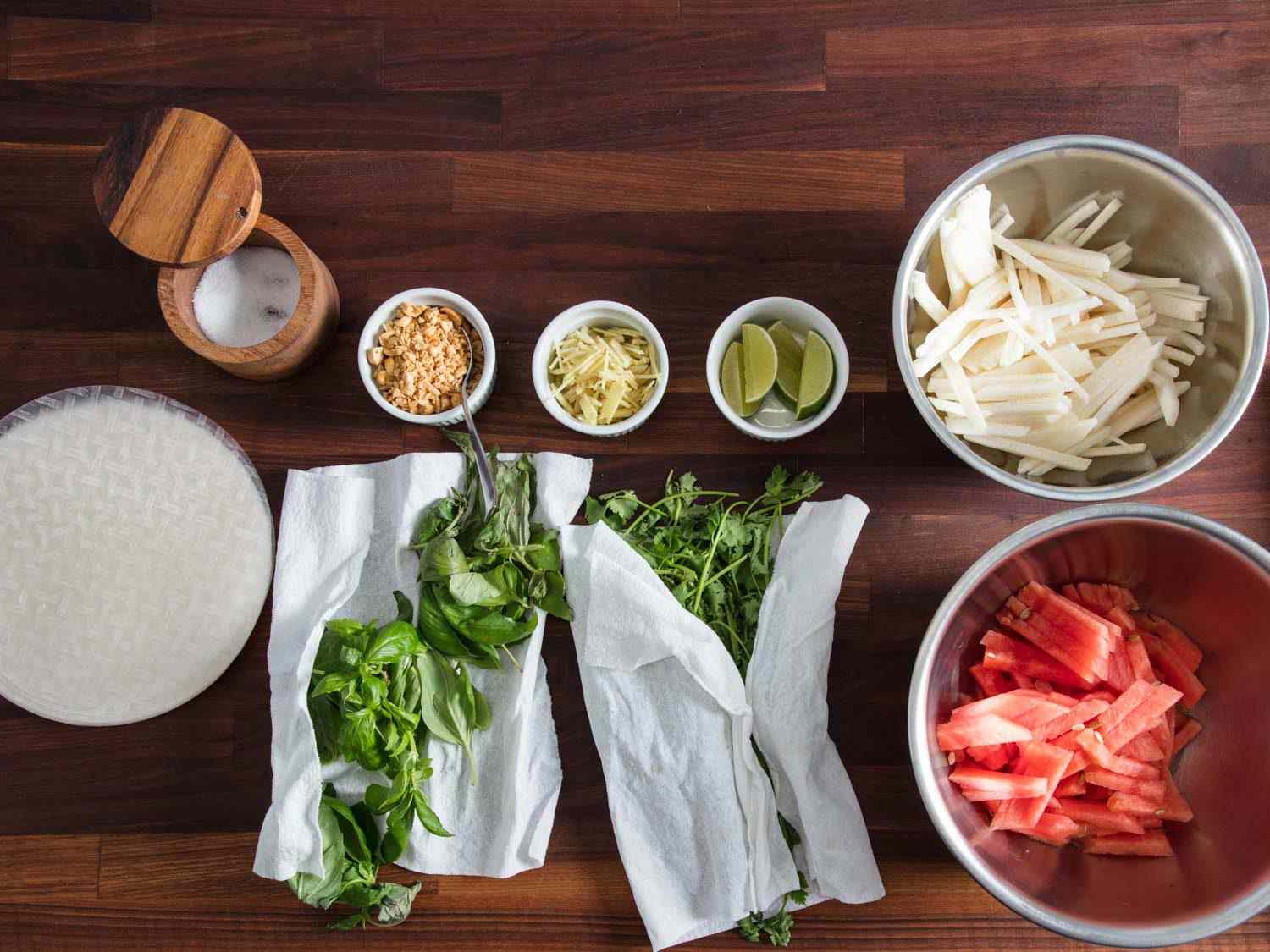 Rice paper wrappers, watermelon matchsticks, jicama matchsticks, chopped peanuts, ginger, herbs