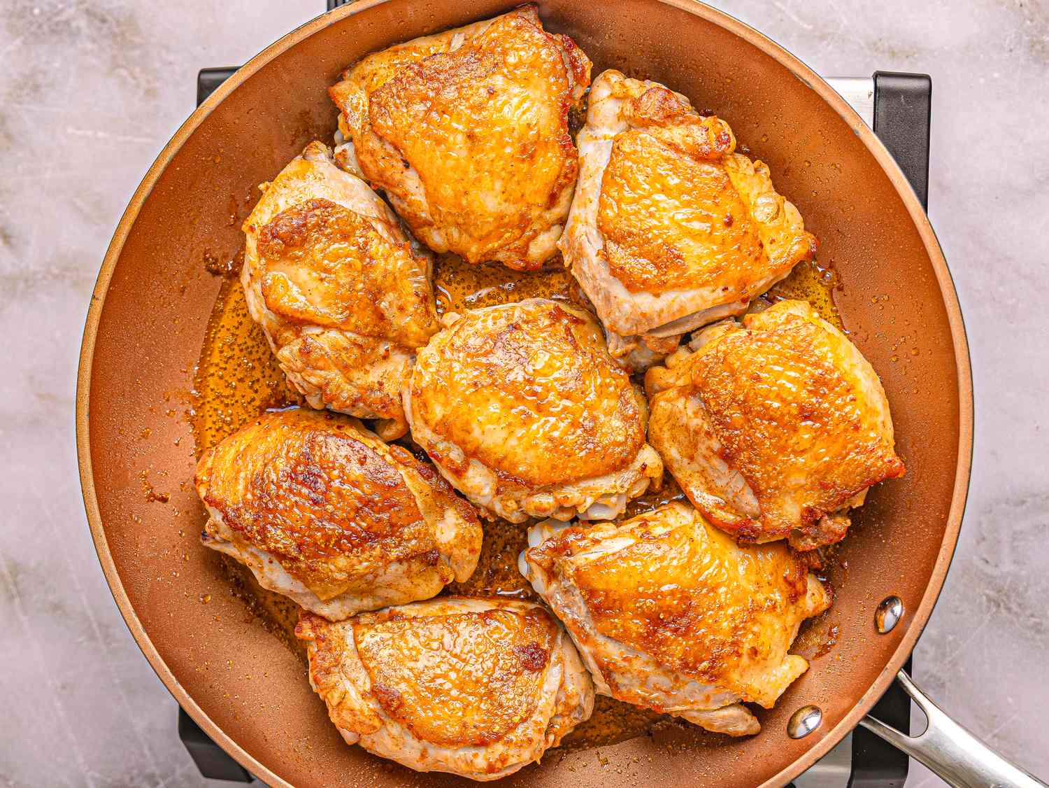 Cooked chicken pieces in a skillet, ready for a recipe or serving