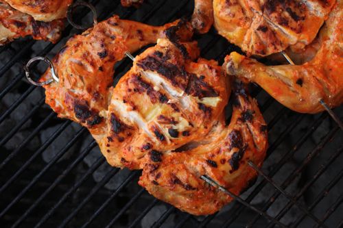 Chicken tikka skewered on a grill
