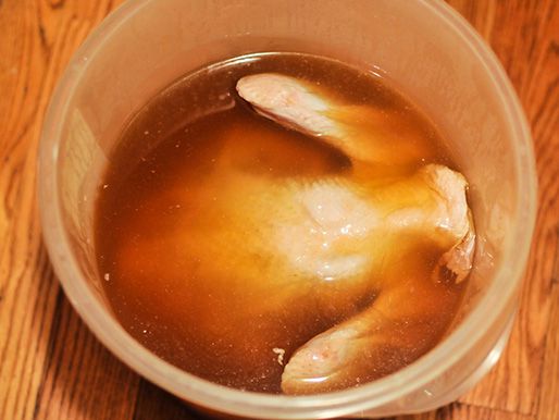 Whole turkey submerged in apple juice and molasses brine