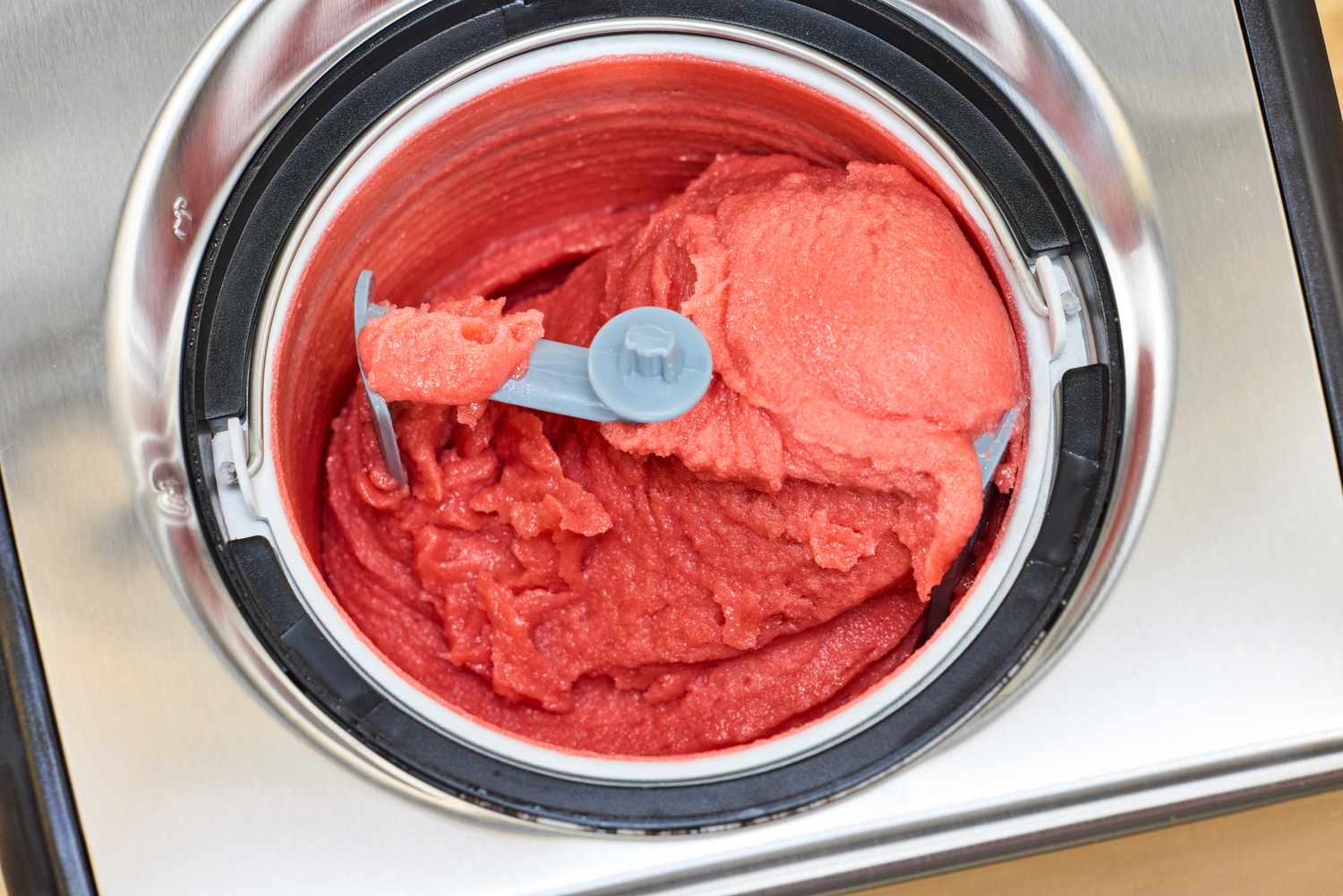 An overhead view of the Cuisinart Compressor Ice Cream and Gelato Maker containing red ice cream