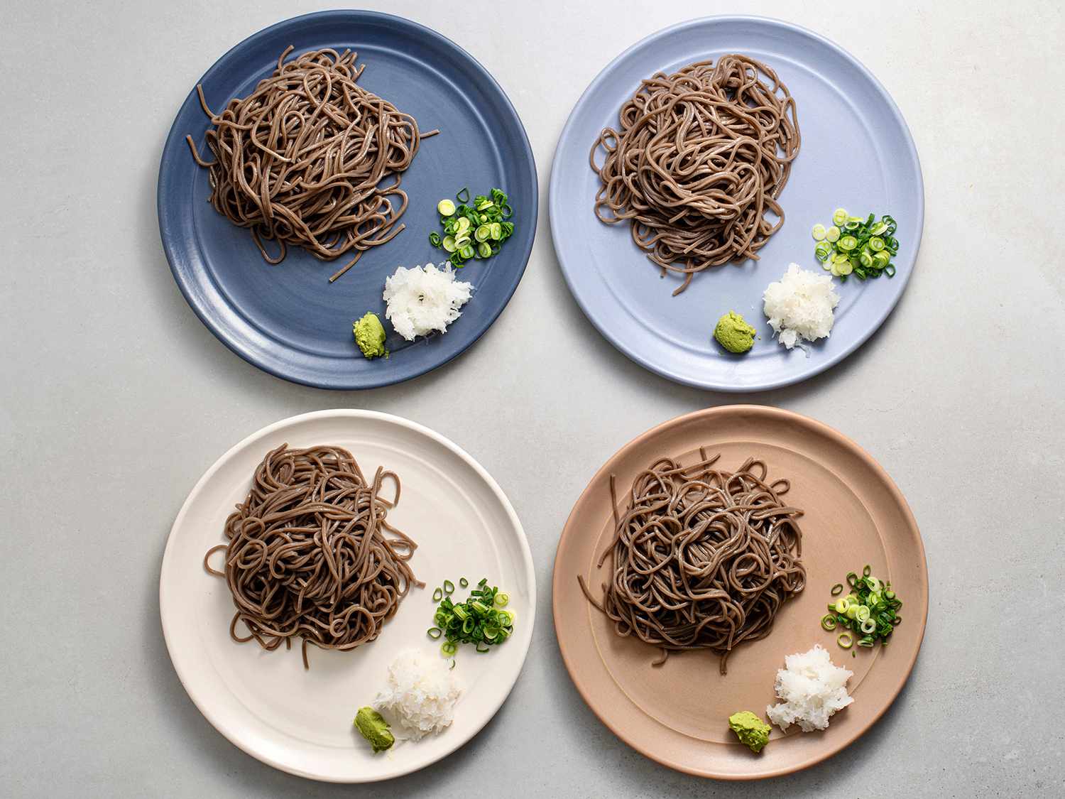 Four plated portions of cold soba noodles 