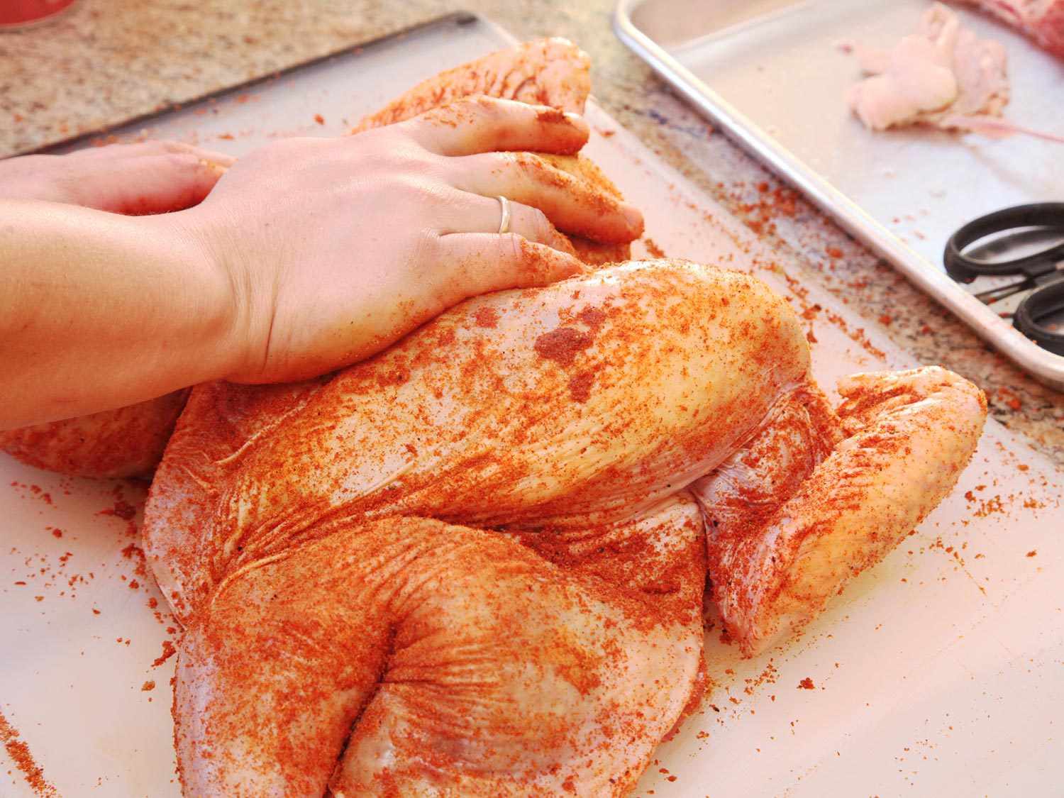 Massaging spice rub into a turkey.