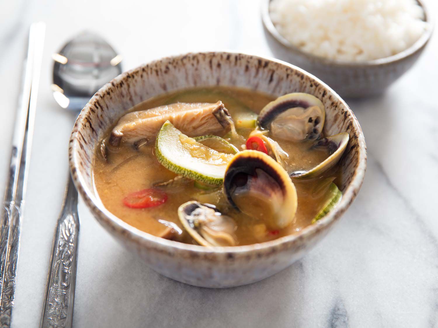Korean Fermented Tofu Stew with clams in ceramic bowl